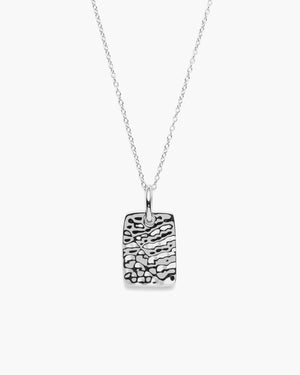 Silver necklace with a textured rectangular pendant on a white background.