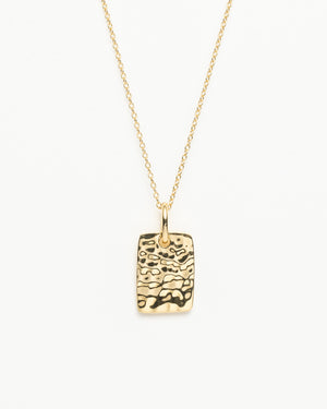 Gold necklace with textured pendant