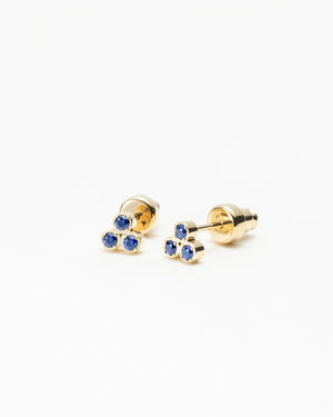 Pair of gold stud earrings with a trio of blue gemstones