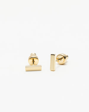 Pair of gold-tone flat-back bar stud earrings, on a white background.