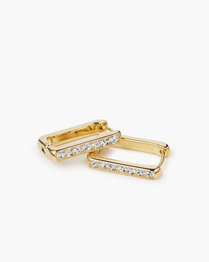 Gold rectangular huggie hoop earrings with white sapphire detailing on white background, product photo