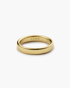 Wide polished gold band ring engraved "LUAH" on the inside, shown on a plain white background.