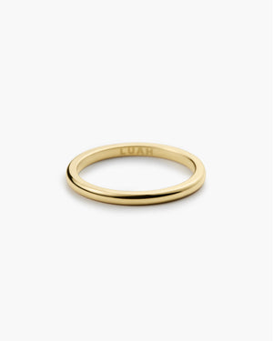 Thin polished gold band ring engraved "LUAH" on the inside, shown on a plain white background.