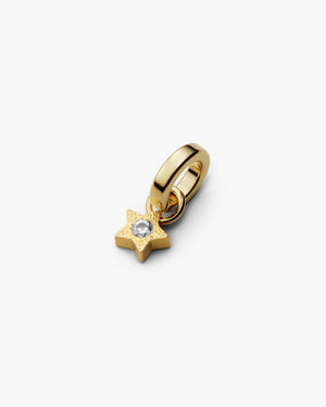 Gold mini star charm with white sapphire gemstone in the center