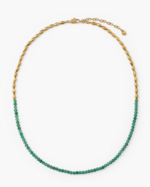Gold beaded necklace with green gemstone beads and lobster clasp on white background