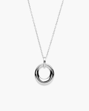 Close-up of thick silver circular pendant against a white background