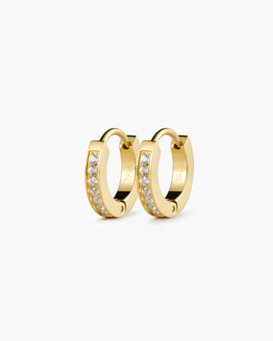 Pair of gold hoop earrings lined with small white sapphire stones, shown on a white background.