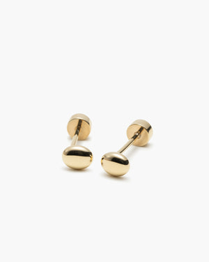 Pair of small gold pebble-shaped stud earrings with screw-back closures, laid on a white background.