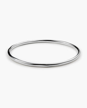 Polished silver bangle bracelet with a smooth, slightly irregular round band, engraved "LUAH" on the surface, laid flat on a white background.