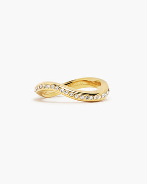 Gold wave-shaped ring lined with white sapphire gemstones, engraved with the LUAH logo