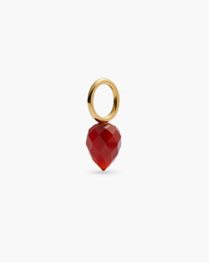 Gold hoop with red gemstone drop charm on a white background