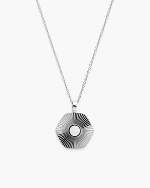 Silver hexagon pendant necklace with ribbed texture on chain, white background