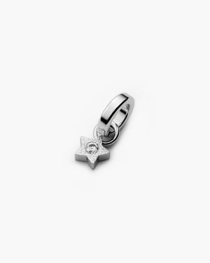 Silver star charm earring with hoop and dangling star pendant featuring a sparkling center stone, shown on a clean white background.