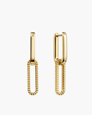 Gold rectangular link drop earrings with textured ribbed oval charm on white background