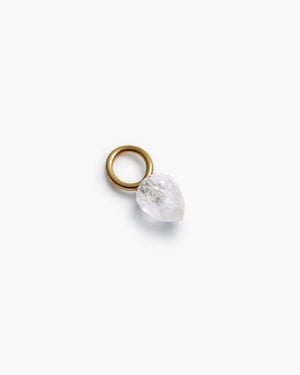 Gold hoop with clear gemstone charm on a white background