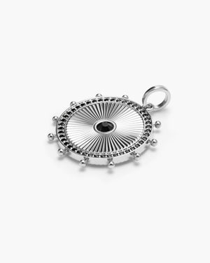 Silver circular medallion charm with a black gemstone center, edged in black gemstones and silver beading