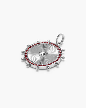 Silver circular medallion charm with a white sapphire gemstone center, edged in red gemstones and silver beading