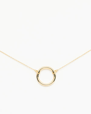 Gold circle pendant necklace on a delicate chain, photographed on a clean white background.