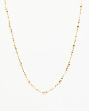 Fine chain necklace with spaced out beaded textures in gold