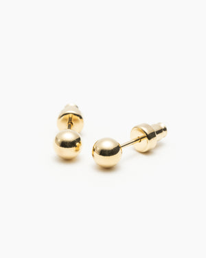 Pair of gold ball stud earrings with screw-back closures, laid on a white background.